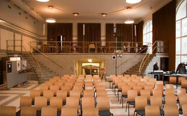 Theater-style layout at Bryggarsalen with mezzanine level for corporate conference events.