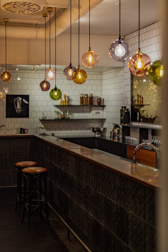 Boutique entrance bar at VENUE81 with ambient lighting for networking mixers and corporate events.
