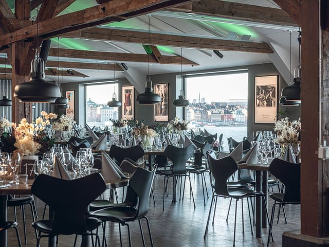Fotografiska conference center with rustic beams and waterfront view for corporate networking events.