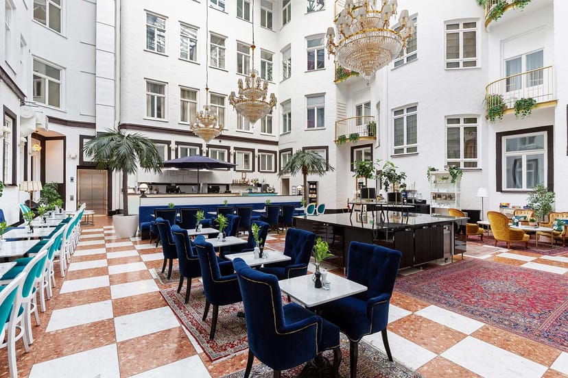 Elegant hotel atrium with crystal chandeliers for networking receptions and corporate events.
