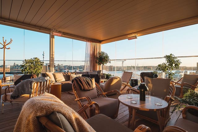Rooftop bar with lounge seating for VIP networking and corporate reception events.