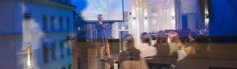 Speaker presenting at Finlandsinstitutet Main Hall seminar, professional event photography.