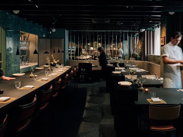 Private dining room at Matbaren featuring sleek, moody decor for exclusive corporate events.