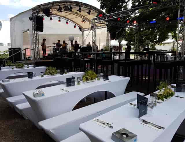 Outdoor event setup at Zollpackhof beer garden with communal seating for corporate events.