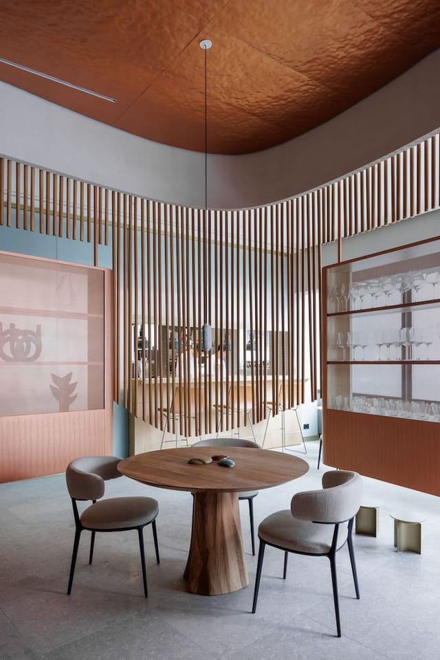 Sophisticated semi-private dining area with slat partitions, ideal for VIP events and networking.