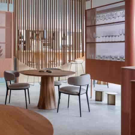 Modern boutique networking restaurant in Orma Roma with stylish seating and sleek bar area.