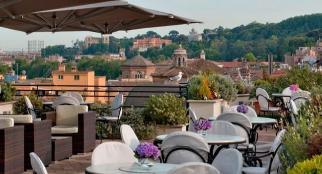 Rooftop garden venue in Rome with panoramic skyline for cocktail receptions and networking events.