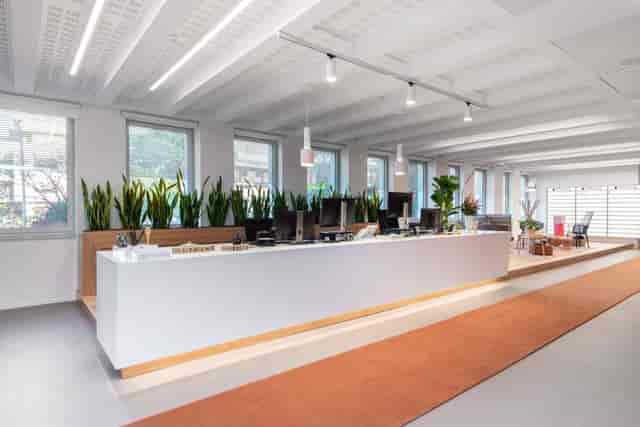 Modern meeting room check-in area with natural light for conference and event registration.