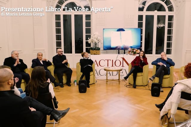 Circular panel discussion setup at Royal Space Rome for professional book presentation event.
