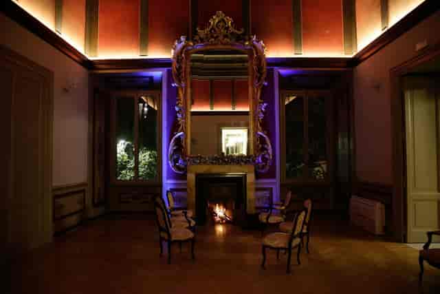 VIP networking breakout space with dramatic lighting in a historic Rome garden venue.