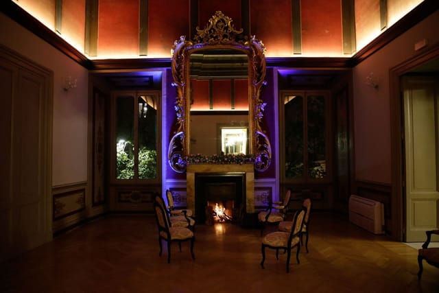 VIP networking breakout space with dramatic lighting in a historic Rome garden venue.