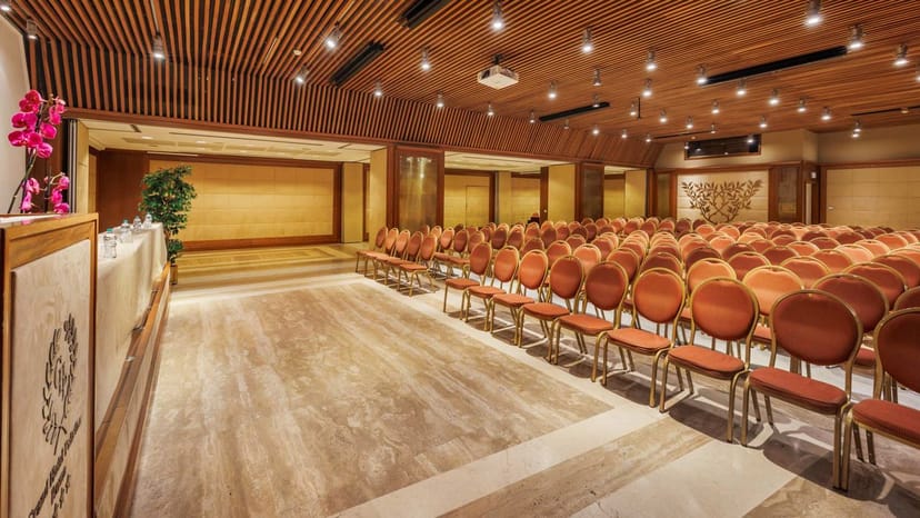 Oceania conference room at Centro Congressi Cavour, wood ceiling, theater-style event venue.