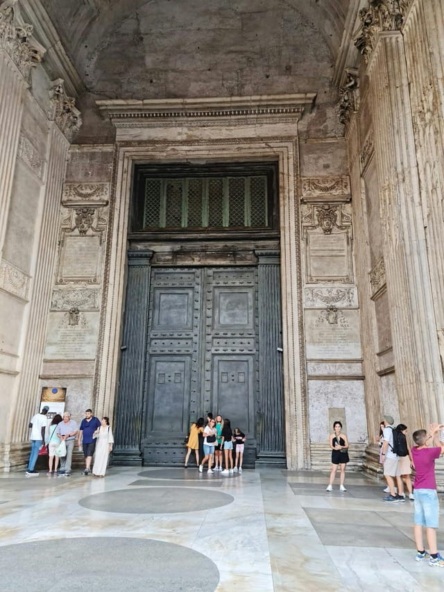 Pantheon entrance with massive historic doors for exclusive gala and red-carpet event venue.