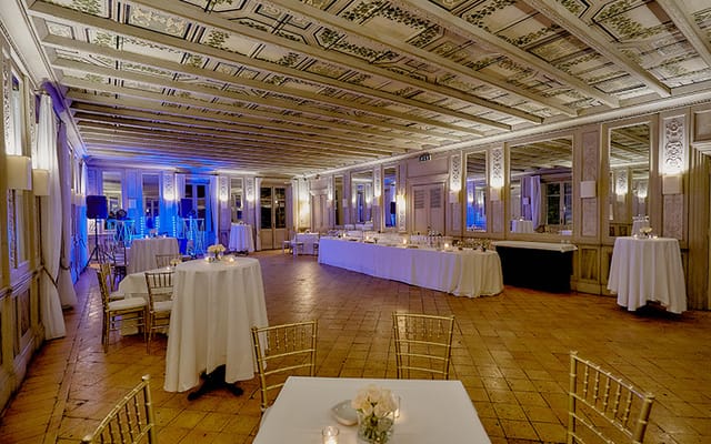 Sala degli Specchi event space with blue uplighting for elegant evening galas and receptions.