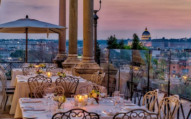 Sala Romana gala dinner venue at Casina Valadier with iconic sunset St. Peter's backdrop.