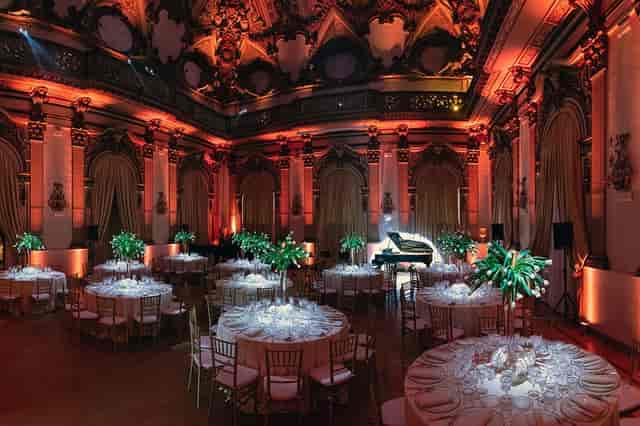 Gala dinner in historic Palazzo Brancaccio ballroom with warm uplighting for formal event hosting.