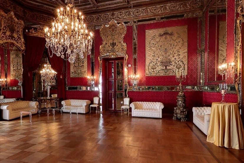 Opulent Sala Rossa ballroom with red decor, ideal for luxury galas and exclusive receptions.