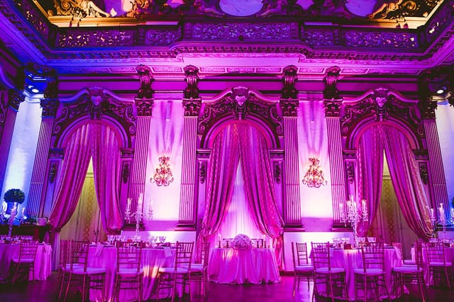 Magenta-lit Sala Rossa ballroom at Palazzo Brancaccio for luxury wedding event decor.