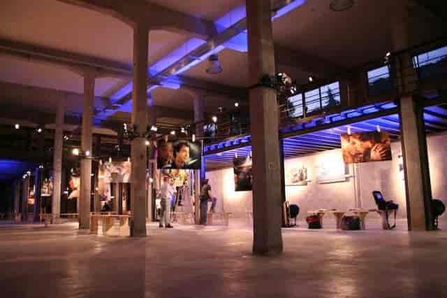 Industrial Sintelco Room at Officine Farneto with ambient lighting for exhibition and event spaces.