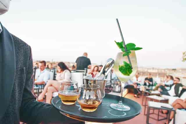 Luxury rooftop networking reception at Terrazza Borromini with premium corporate event service.