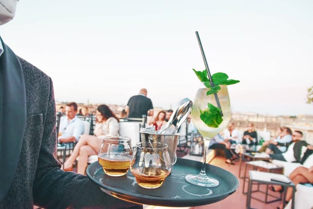 Luxury rooftop networking reception at Terrazza Borromini with premium corporate event service.