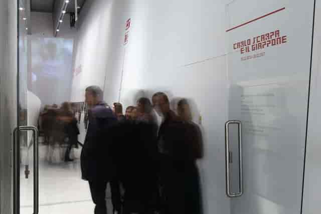 Minimalist gallery signage at MAXXI museum exhibition entrance for event crowd control.