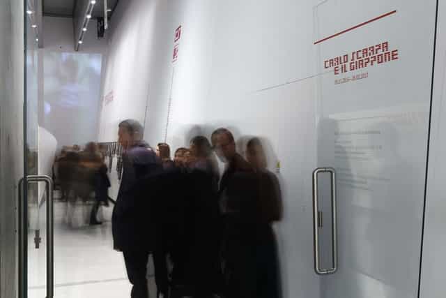 Minimalist gallery signage at MAXXI museum exhibition entrance for event crowd control.