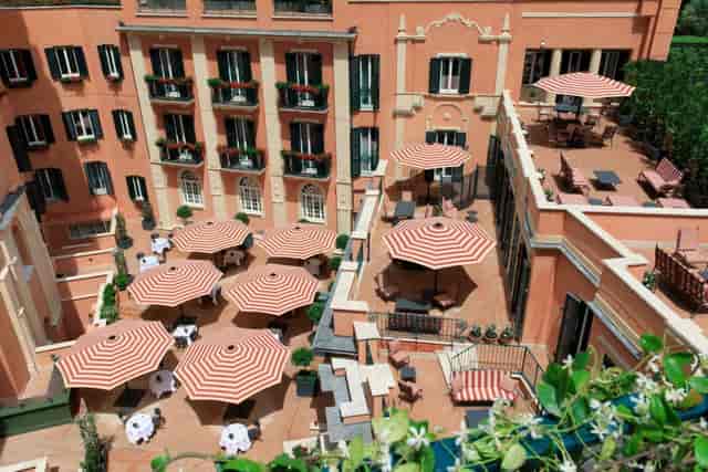Multi-level hotel courtyard for upscale networking events and corporate coffee breaks.