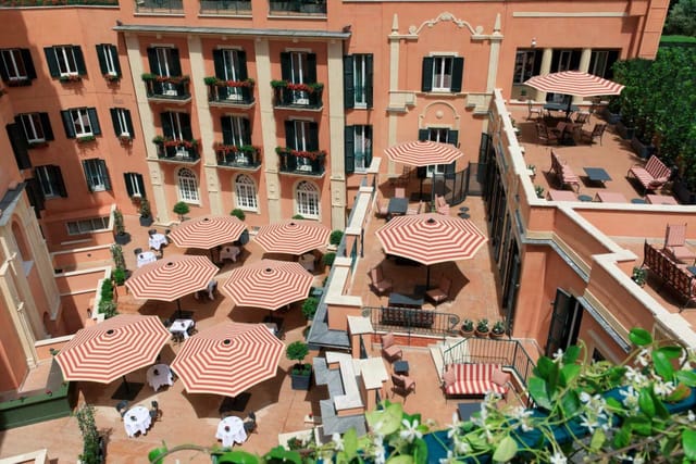 Multi-level hotel courtyard for upscale networking events and corporate coffee breaks.