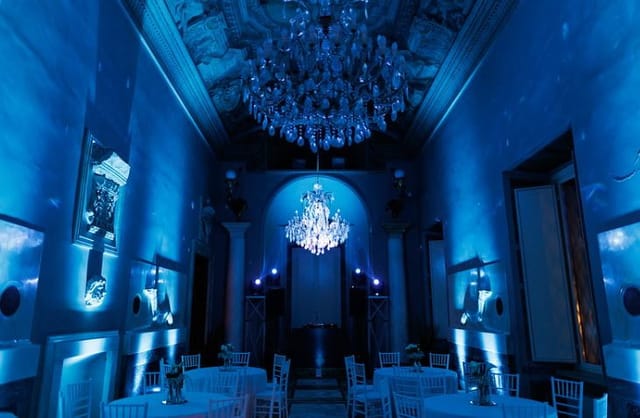 Villa Brasini garden venue with blue uplighting for luxury corporate events and gala dinners.