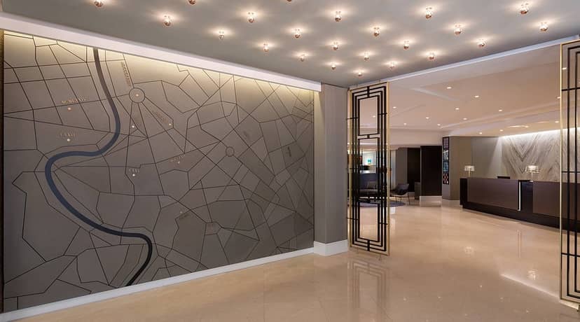 Le Méridien Visconti Rome hotel lobby with statement map wall for corporate event registration.