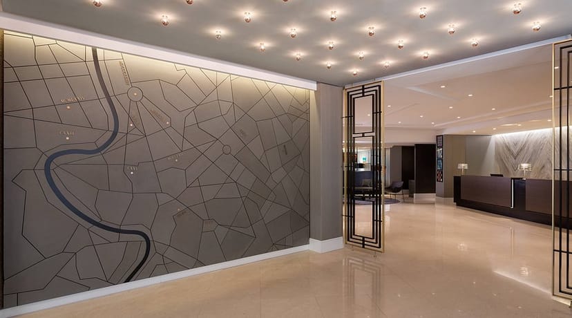 Le Méridien Visconti Rome hotel lobby with statement map wall for corporate event registration.