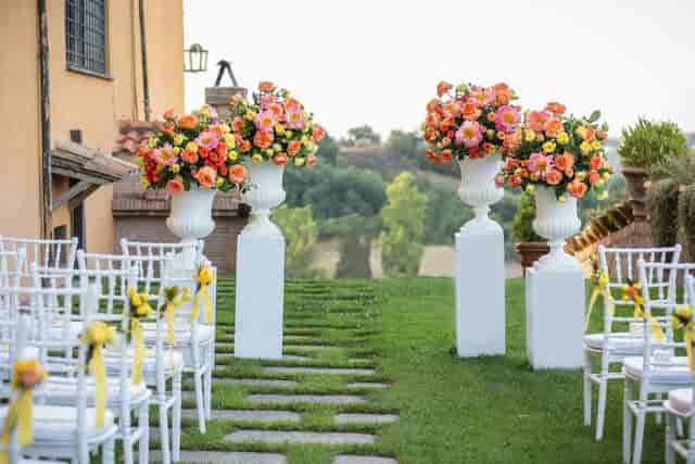 Well Courtyard wedding ceremony with floral plinths at Castello di Decima luxury event venue.