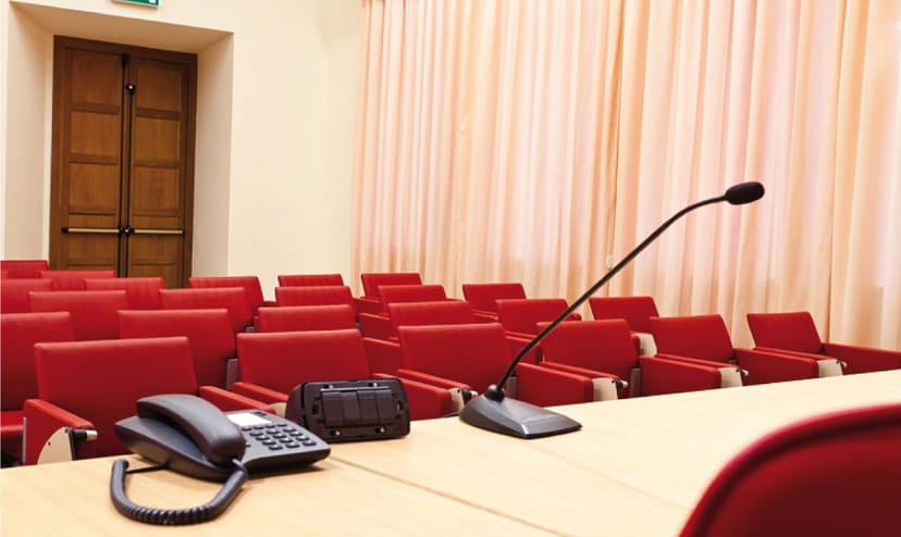 Theater-style Auditorium Antonianum breakout room with lectern for formal corporate presentations.