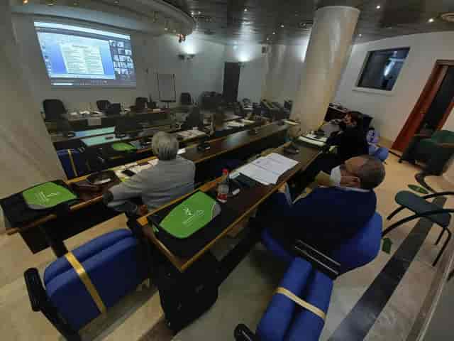 Hybrid conference room at Centro Congressi Frentani with tiered classroom seating and screen.