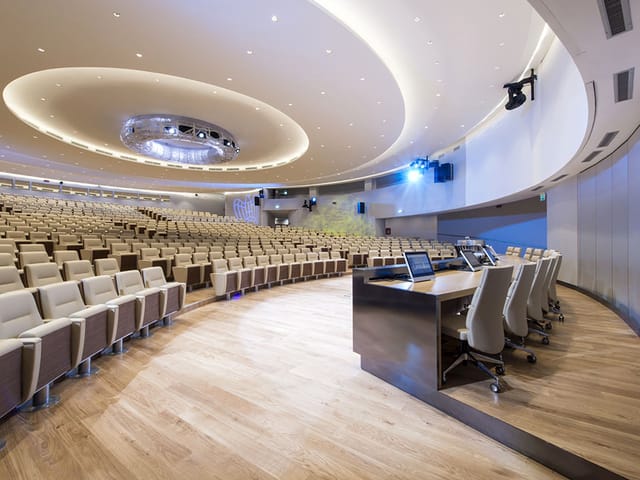 Sala Accademia auditorium with tiered seating for executive keynotes and academic symposia.