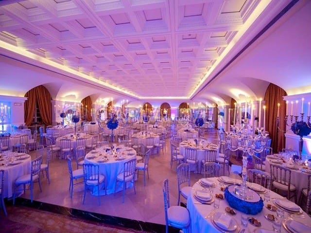 Villa Miani ballroom with violet lighting and candelabras for a luxury wedding or gala event.