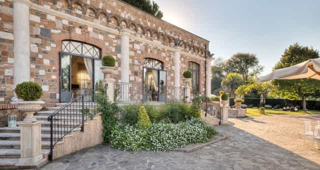 Historic stone ballroom at Nuova Villa dei Cesari: elegant outdoor venue for weddings and retreats.