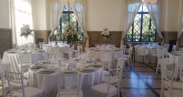 Elegant gala reception room with white linens and Chiavari chairs for luxury events.