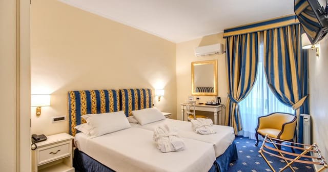 Hotel Napoleon twin room with classic decor for business conferences and event accommodation.