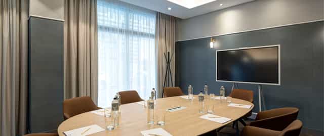 Modern boardroom at DoubleTree Rome Monti with natural light for executive meetings and events.