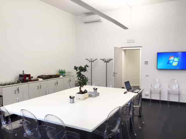 Montecitorio Meeting Centre conference room, white minimalist boardroom for corporate meetings.