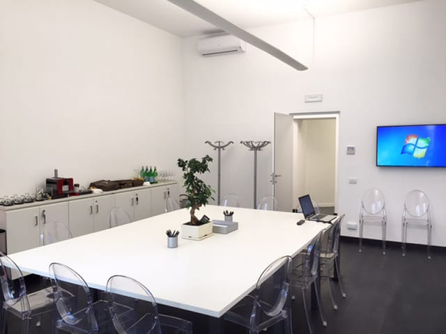 Montecitorio Meeting Centre conference room, white minimalist boardroom for corporate meetings.