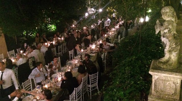 Al fresco long-table gala dinner at Villa Sospisio with elegant ambient lighting.