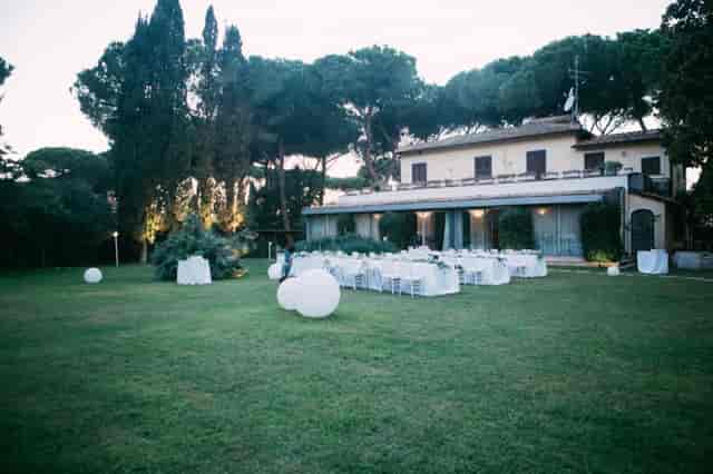 Elegant outdoor garden reception at Villa Trebazia with sphere lighting for weddings and events.