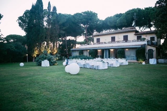 Elegant outdoor garden reception at Villa Trebazia with sphere lighting for weddings and events.
