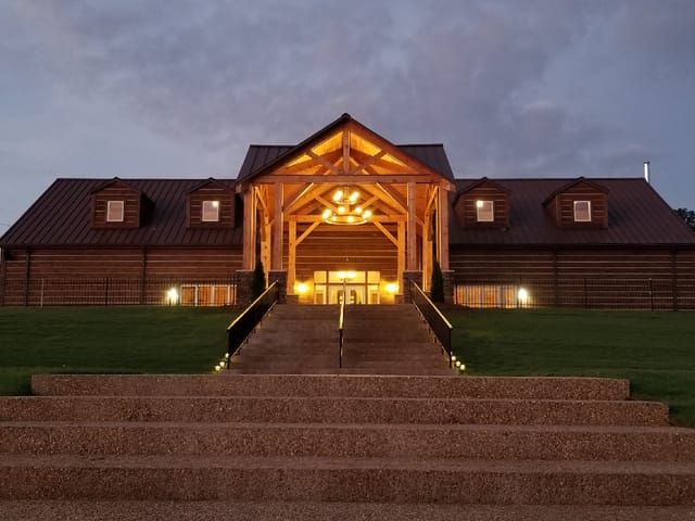 Rustic-luxe Lakehouse venue entrance with dramatic lighting for gala and retreat events.