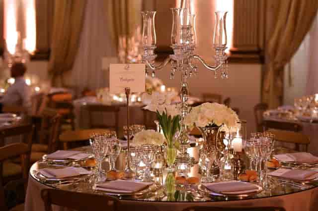 Gala tablescape with crystal candelabra in Brancaccio Palace ballroom for luxury event decor.