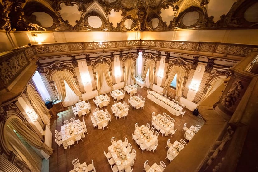 Brancaccio Palace ballroom gala dinner with elegant banquet tables and historic architecture.