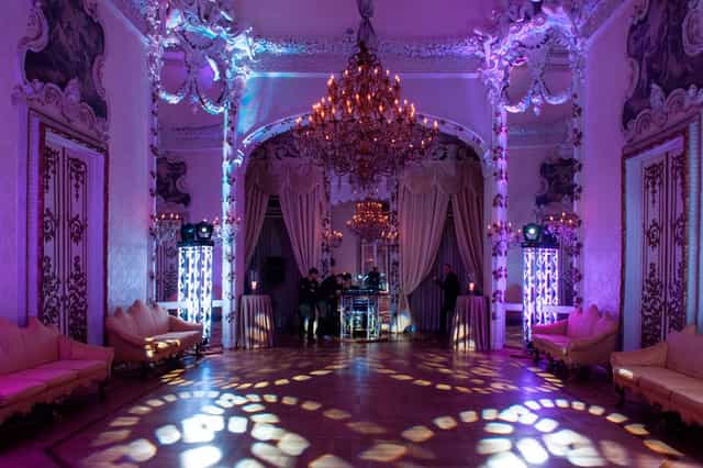 Tapestry Lounge gala event: ornate palace architecture with vibrant LED event lighting.